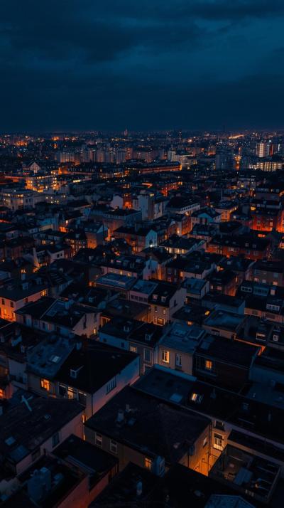 City Rooftops At Night With Glowing Windows