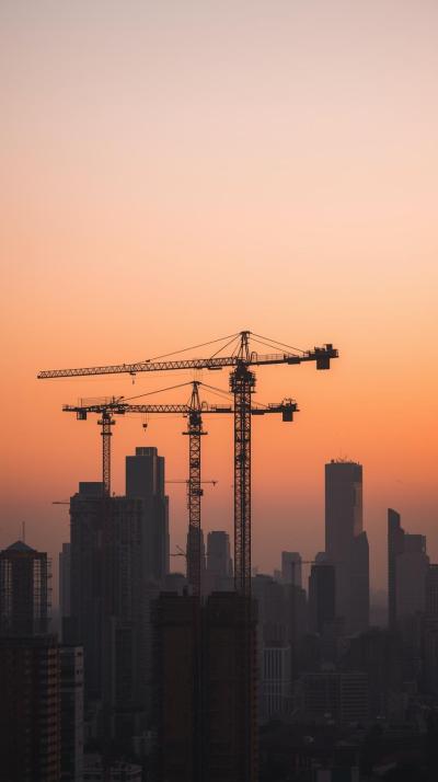 Construction Cranes Over A Developing City